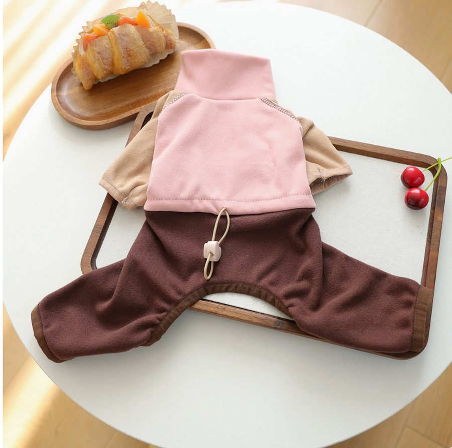 Flat lay of the Blush / Cocoa dog onesie showing color panels and back toggle