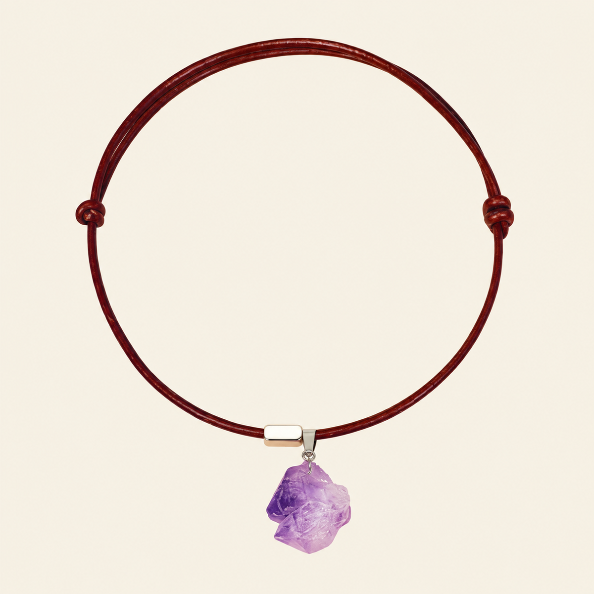 Raw purple amethyst pendant on an adjustable reddish-brown leather cord