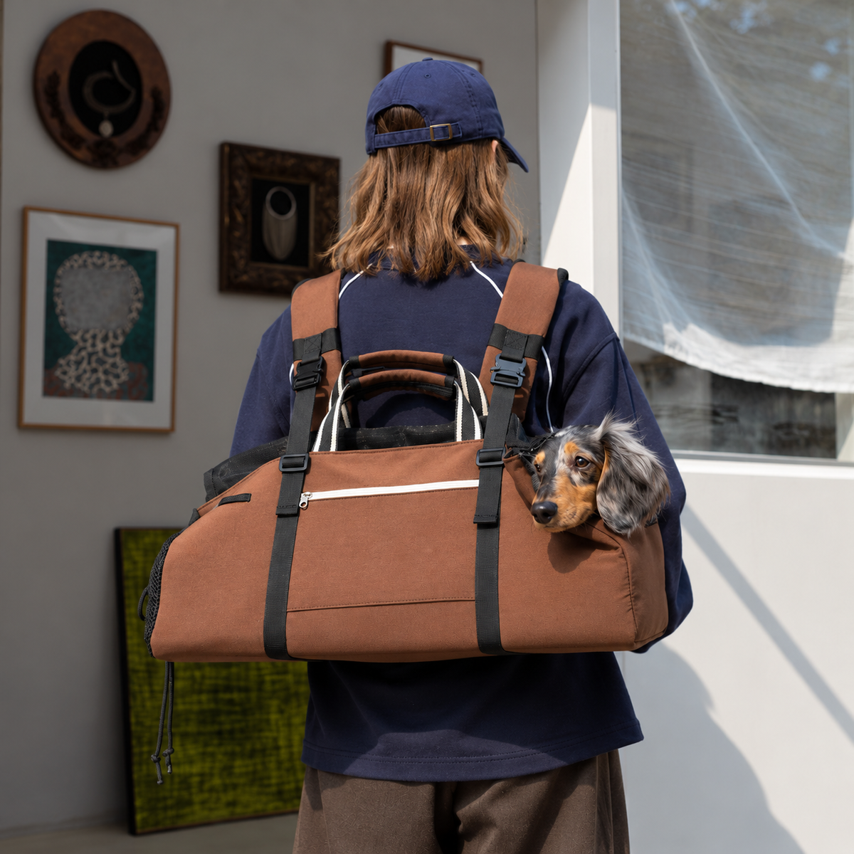 Brown three-way carrier worn as a backpack with the dog's head visible